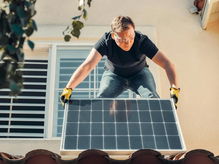 a man standing on top of a roof with a solar panel, a stock photo, by Carey Morris, shutterstock, renaissance, an intruder, better homes and gardens, australian, 💣 💥💣 💥