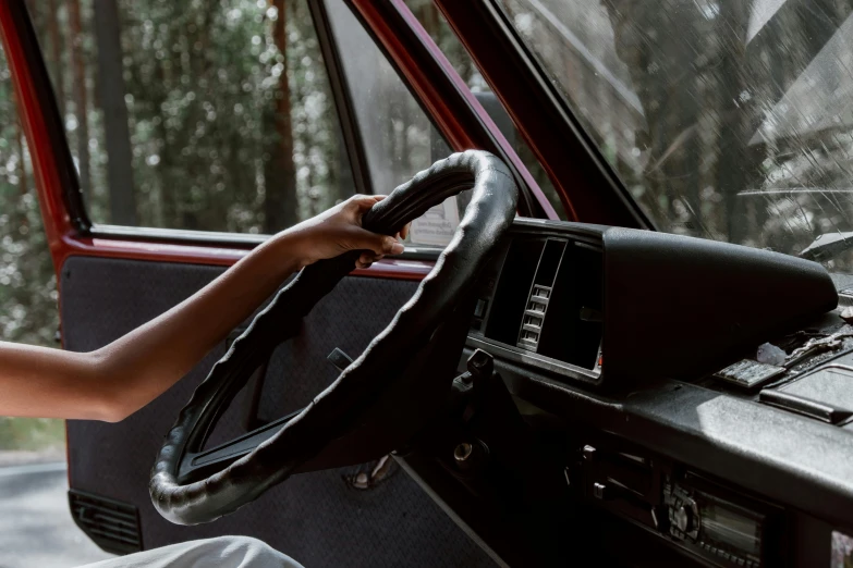 a woman sitting in the driver's seat of a car, pexels contest winner, maroon and white, kombi, cruise control, retro and 1 9 8 0 s style