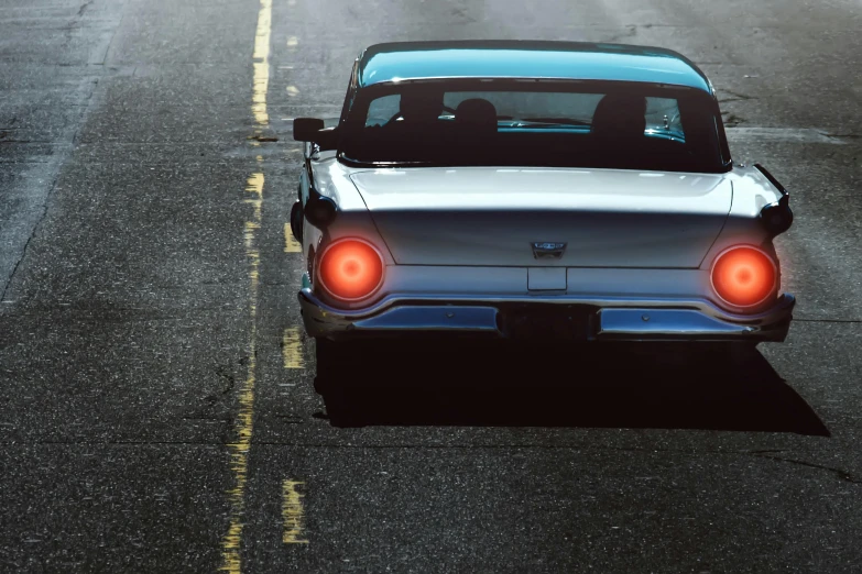 a car that is sitting on the side of the road, inspired by Elsa Bleda, pexels contest winner, retrofuturism, thunderbirds, back lit, seattle, highly detailed hyper real retro