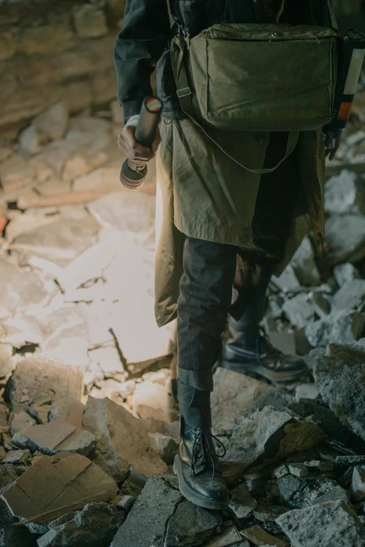 a man walking through the rubble of a building, pexels contest winner, renaissance, tactical gear, wearing russian ww 1 clothes, strong cinematic light, military boots