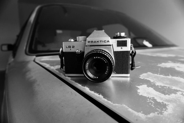 a black and white photo of a camera on top of a car, a black and white photo, by Jaakko Mattila, 8 0 s camera, [ realistic photography ], f2.8, beautiful photograph