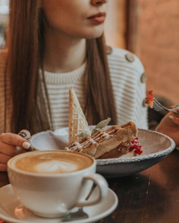 a woman sitting at a table with a plate of food and a cup of coffee, cake in hand, sharing a pizza, profile image, multiple stories