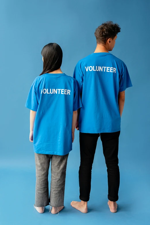 a couple of people standing next to each other, blue shirt, 2 colour print, back - shot, ((blue))