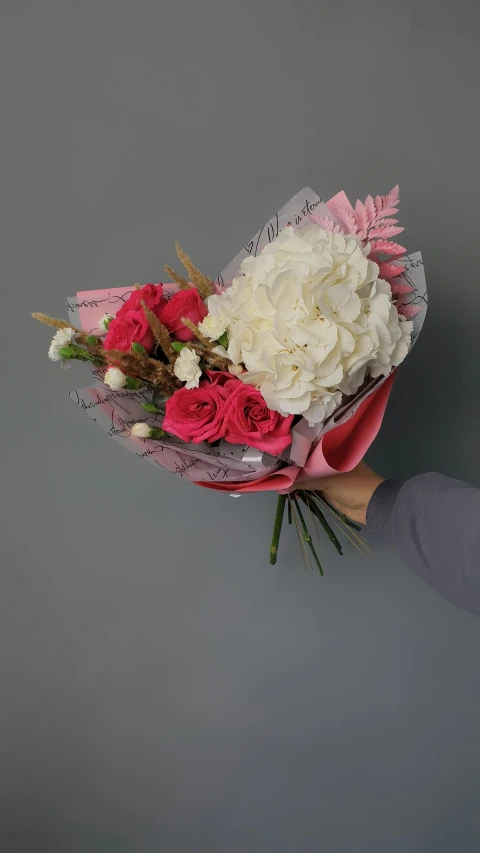 a woman holding a bouquet of pink and white flowers, on a gray background, hey buddy, award winning, red and white