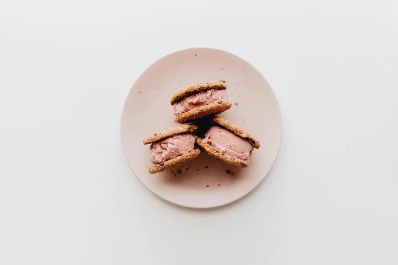 three ice cream sandwiches on a pink plate, unsplash, modernism, detailed product image, on a white table, beef, high quality product image”