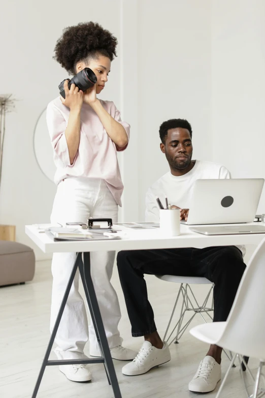 a couple of people sitting at a table with laptops, pexels contest winner, visual art, in a white room, shooting, at a fashion shoot, thumbnail