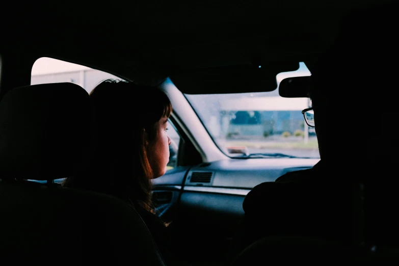 a couple of people that are sitting in a car, pexels contest winner, square, obscured underexposed view, backfacing, teenage girl