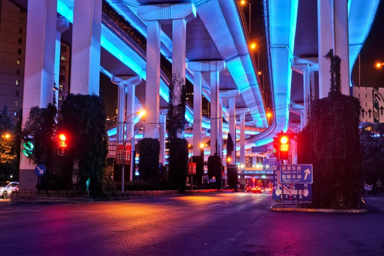 a city street filled with lots of traffic lights, inspired by David LaChapelle, pexels contest winner, blue lamps on the ceiling, under bridge, blue and purle lighting, orange and cyan lighting