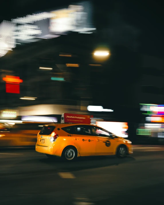 a taxi driving down a city street at night, pexels contest winner, happening, square, low quality photo, thumbnail, multiple stories