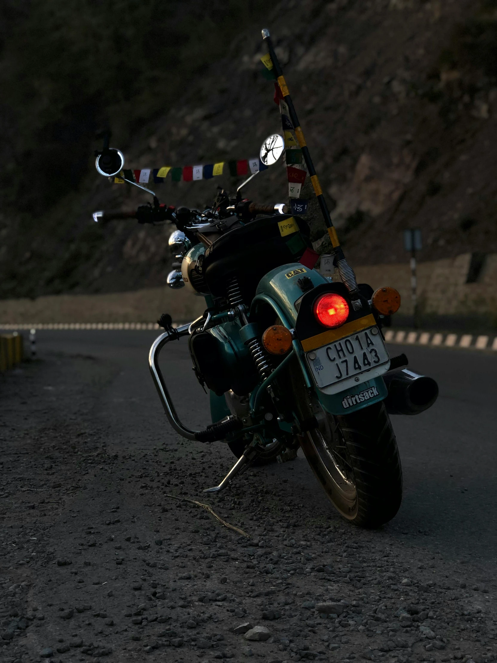 a motorcycle is parked on the side of the road, by Saurabh Jethani, pexels contest winner, cyan headlights, hight decorated, avatar image, zoomed out view