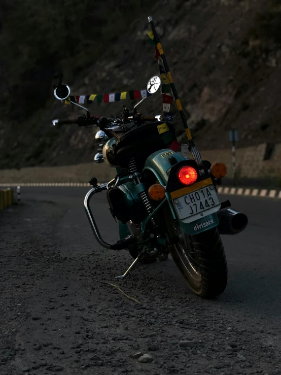 a motorcycle is parked on the side of the road, by Saurabh Jethani, pexels contest winner, cyan headlights, hight decorated, avatar image, zoomed out view