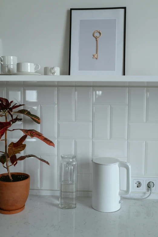 a potted plant sitting on top of a kitchen counter, inspired by Knud Agger, unsplash contest winner, minimalism, white mug, flat shaped chrome relief, made of all white ceramic tiles, kettle