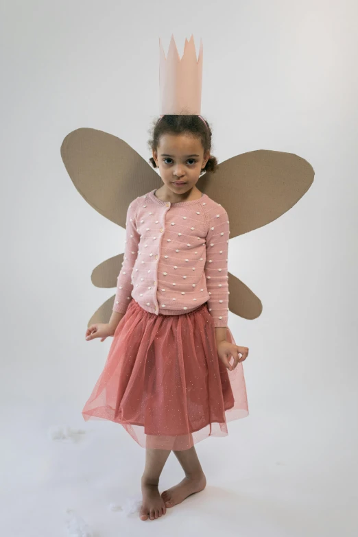 a little girl dressed up in a fairy costume, hurufiyya, full product shot, peach embellishment, dragonfly-shaped, het meisje met de parel