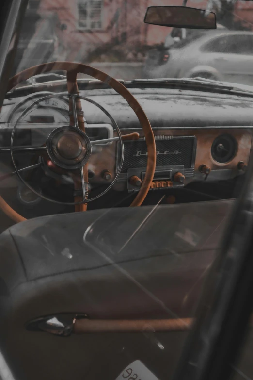 a close up of a steering wheel and dashboard of a car, a picture, by Sven Erixson, pexels contest winner, modernism, faded and dusty, square, promo image, brown
