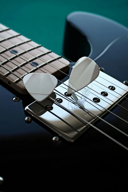 a close up of a black electric guitar