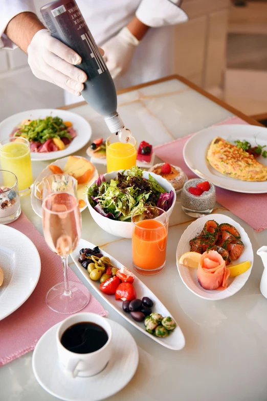 a table topped with plates of food and glasses of wine, breakfast, pink, profile image, all around