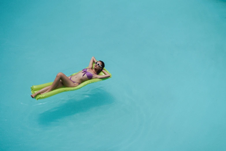 a woman laying on an inflatable raft in a pool, by Matthias Stom, pexels, slide show, hanging, floating. greenish blue, premium quality