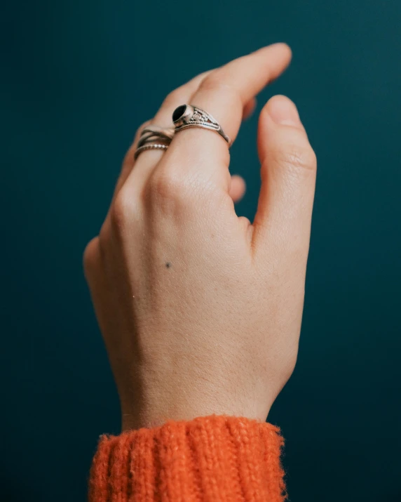 a woman's hand with a ring on her finger, inspired by L. A. Ring, happening, non-binary, instagram story, studio portrait photo, silver jewellery