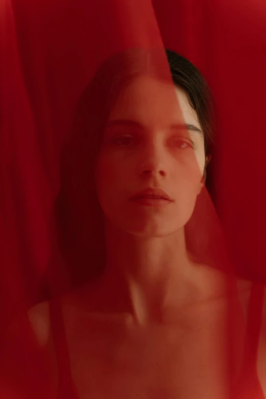 a woman standing in front of a red curtain, an album cover, inspired by Elsa Bleda, pexels contest winner, renaissance, lana del rey and zoë kravitz, francis bacon and agnes cecile, close-up portrait film still, david hamilton