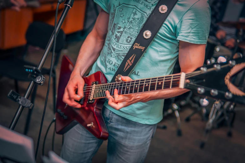 a man playing a guitar in front of a microphone, by Joe Bowler, pexels contest winner, figuration libre, 15081959 21121991 01012000 4k, holding electric guitars, lachlan bailey, low detail