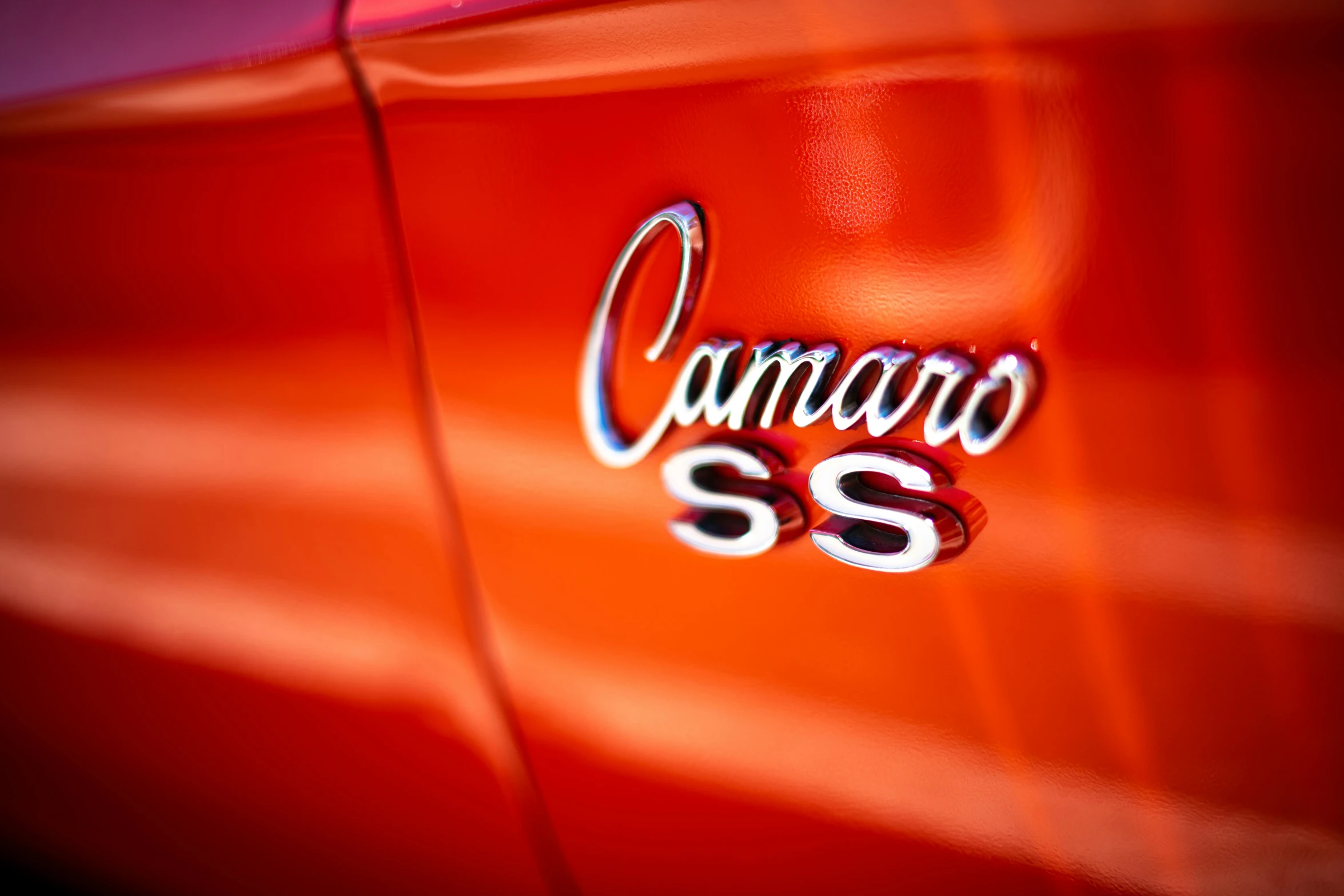 a close up of a car's emblem on a red car, by Carey Morris, pexels contest winner, caramel, sss, lettering clean, camaraderie