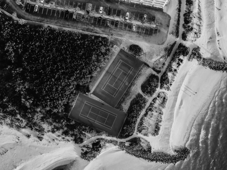 a black and white photo of a tennis court, realism, coastline, topview map, in a beachfront environment, 8k photo