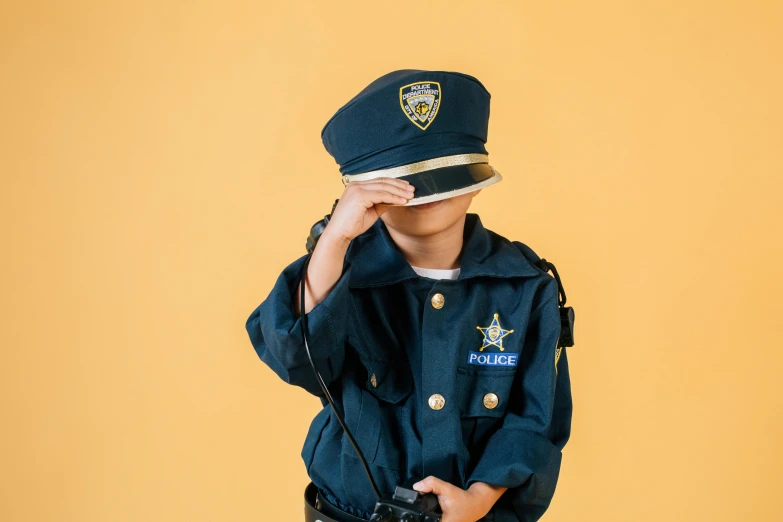 a little boy dressed up as a police officer, trending on pexels, pop art, girl wearing uniform, post graduate, thumbnail, diverse