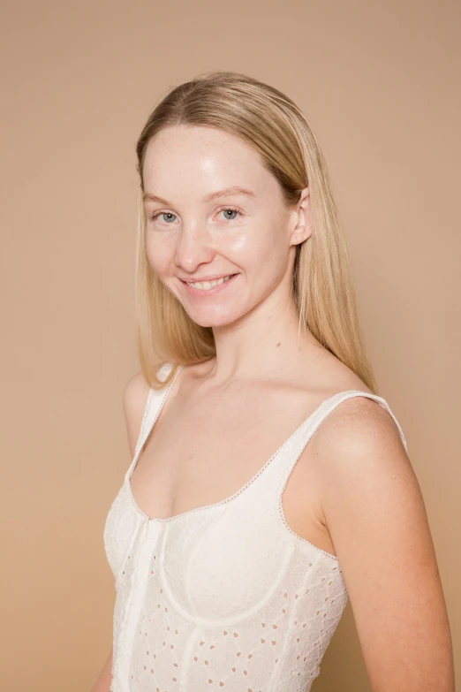 a woman in a white dress posing for a picture, her skin is light brown, with a white complexion, product introduction photo, mia kischner