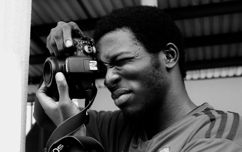 a man taking a picture with a camera, a black and white photo, by Willian Murai, adebanji alade, face focused, uploaded, high quality image