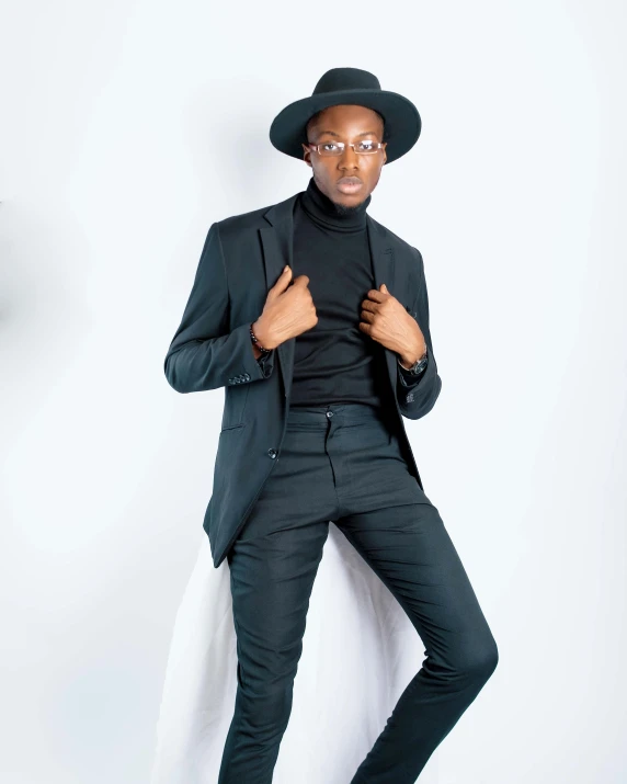 a man in a suit and hat posing for a picture, trending on pexels, panel of black, fully body pose, emmanuel shiru, androgyny