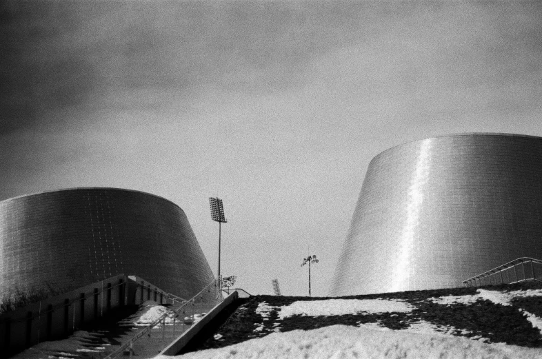a black and white photo of a building, by Modest Urgell, stadium landscape, two organic looking towers, nuclear winter, 5 0 mm kodak