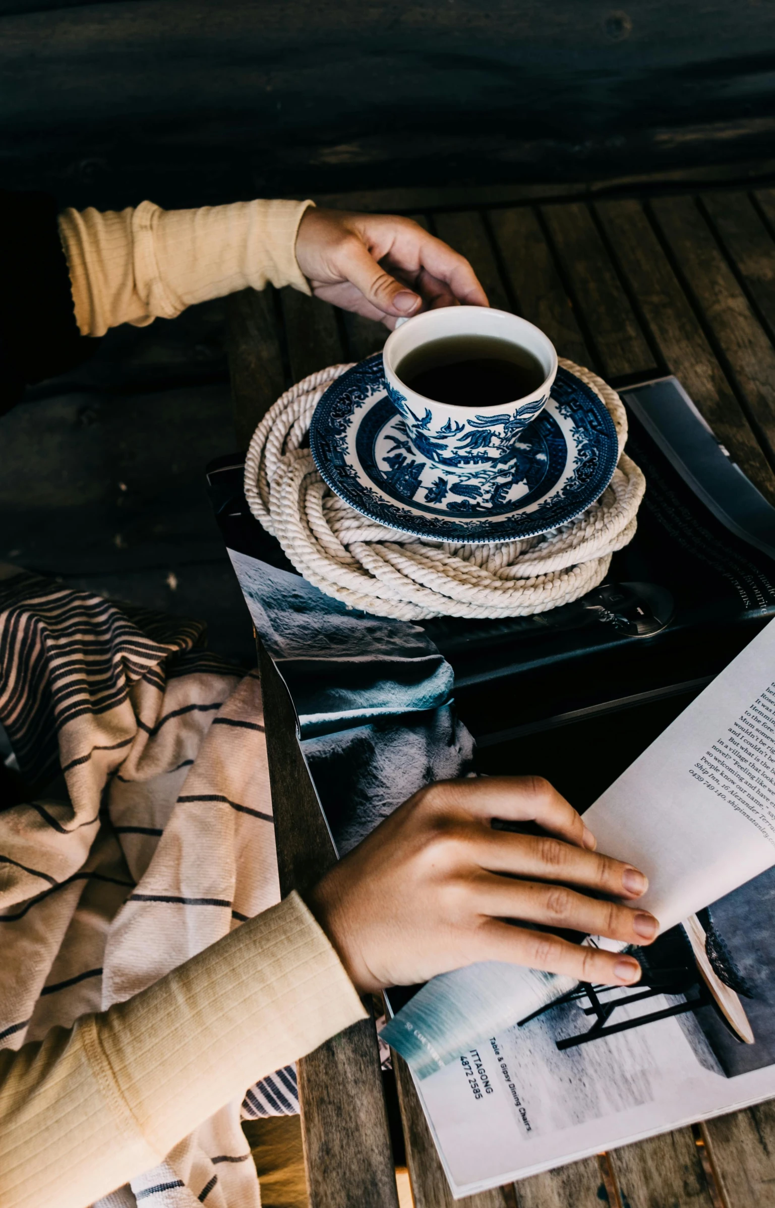 a person sitting at a table with a book and a cup of coffee, pexels contest winner, deep blue mood, curated collections, vintage vibe, 15081959 21121991 01012000 4k