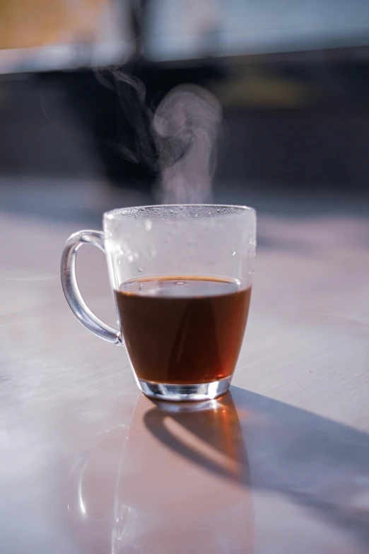 a cup of coffee sitting on top of a table, liquid smoke, with clear glass, drinking tea, subtle detailing