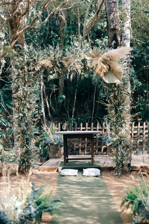 a wooden gazebo sitting in the middle of a lush green forest, holy ceremony, chest covered with palm leaves, eerie shimmering surroundings, an ethereal