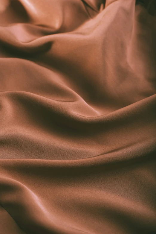 a close up of a brown cloth on a bed, flowing salmon-colored silk, ultra smooth, chocolate, pearlescent hues