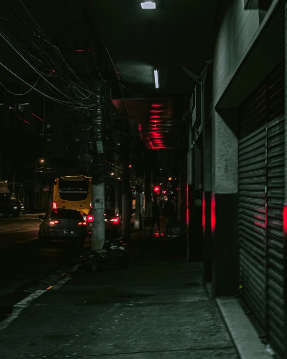 a yellow fire hydrant sitting on the side of a road, inspired by Elsa Bleda, unsplash contest winner, quiet tokyo alley at night, red lighting on their faces, in a dark corridor, wires hanging above street