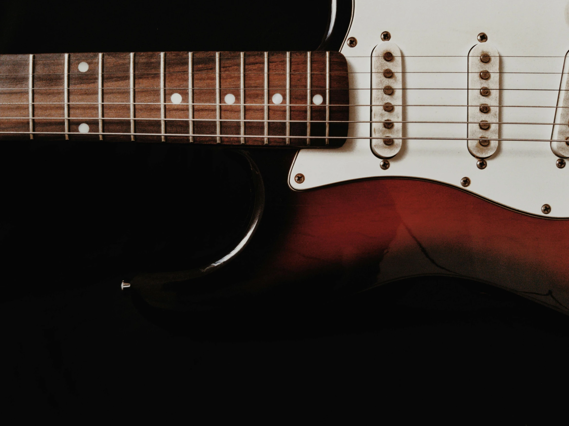 a close up of a guitar on a black background, pexels contest winner, gradient brown to white, gradient brown to red, instagram post, ground - level medium shot