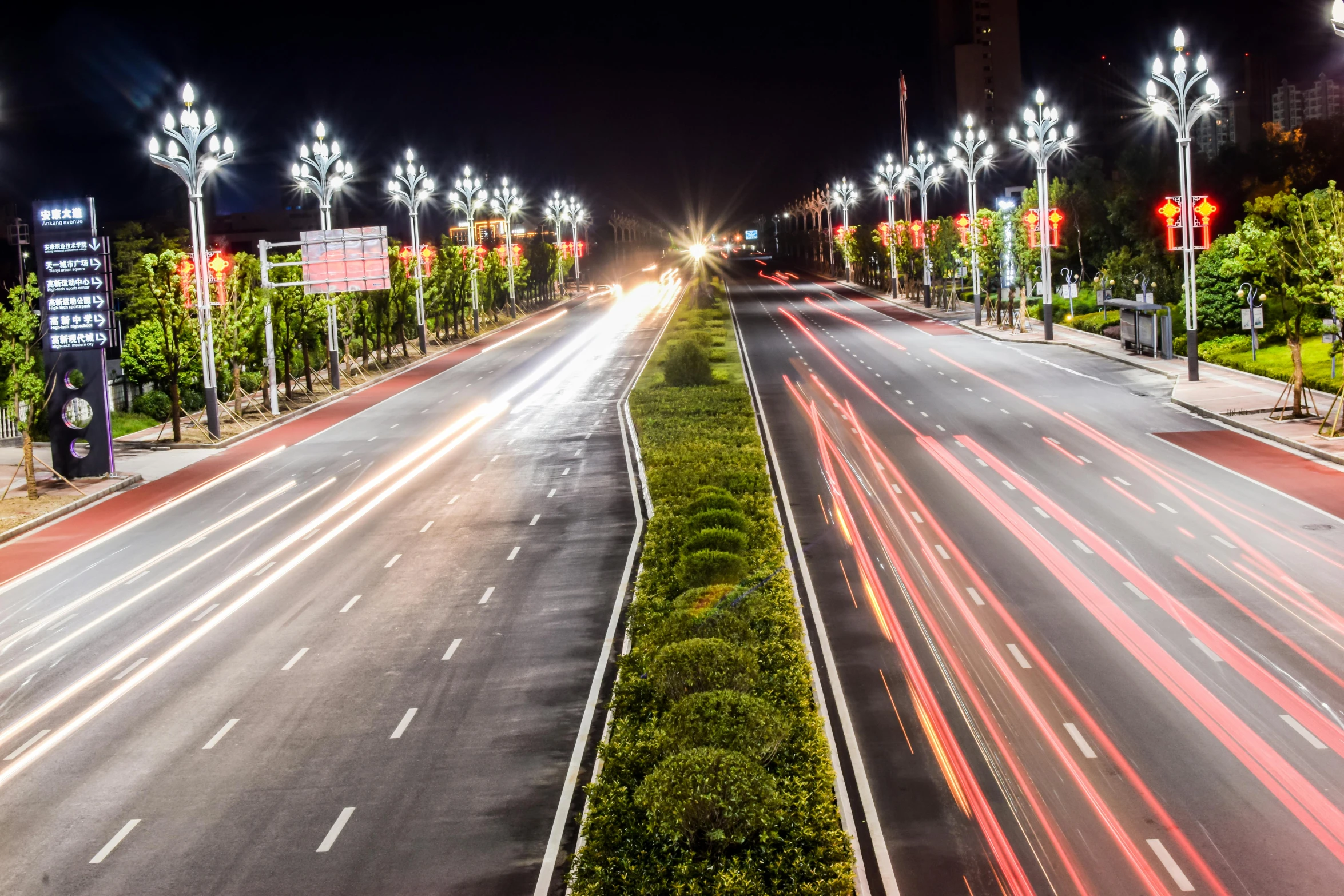 a city street filled with lots of traffic at night, by Alexander Fedosav, unsplash contest winner, realism, pyongyang city, street lighting, city lights made of lush trees, lighting on concrete