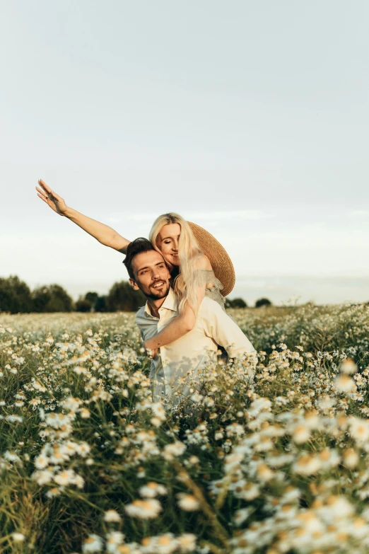 a man carrying a woman in a field of flowers, pexels contest winner, having fun in the sun, white, daisies, lachlan bailey