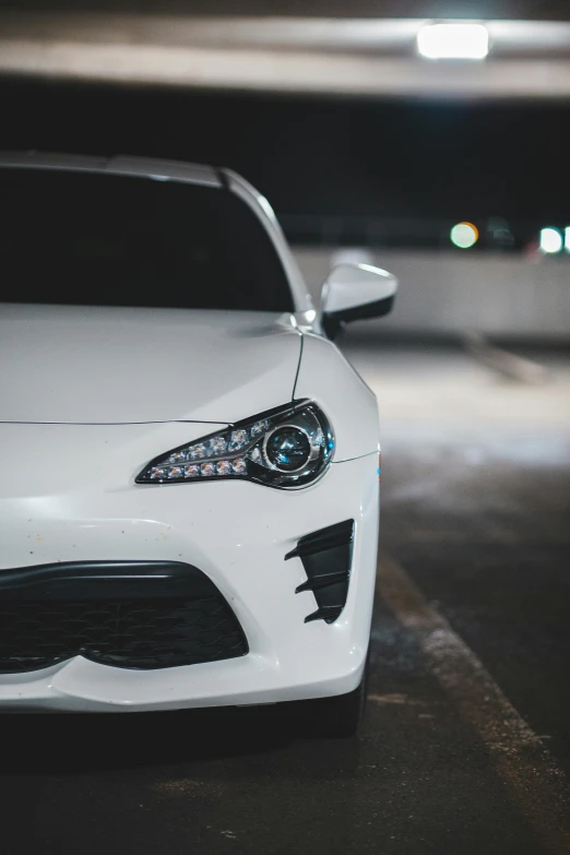 a white sports car parked in a parking garage, by Jason Felix, pexels contest winner, front light, clean detail 4k, anime car wrap, close up half body shot