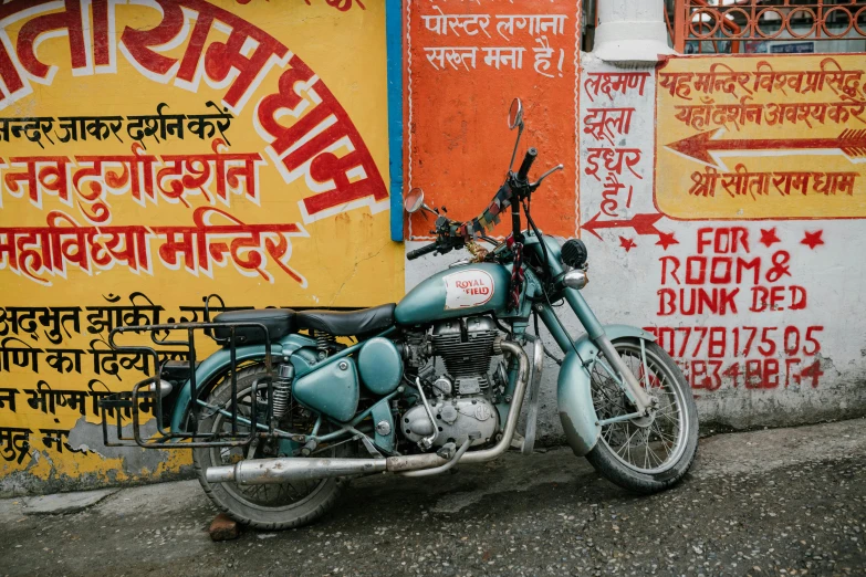 a motorcycle parked on the side of a building, pexels contest winner, on an indian street, martin parr, street of teal stone, 🚿🗝📝