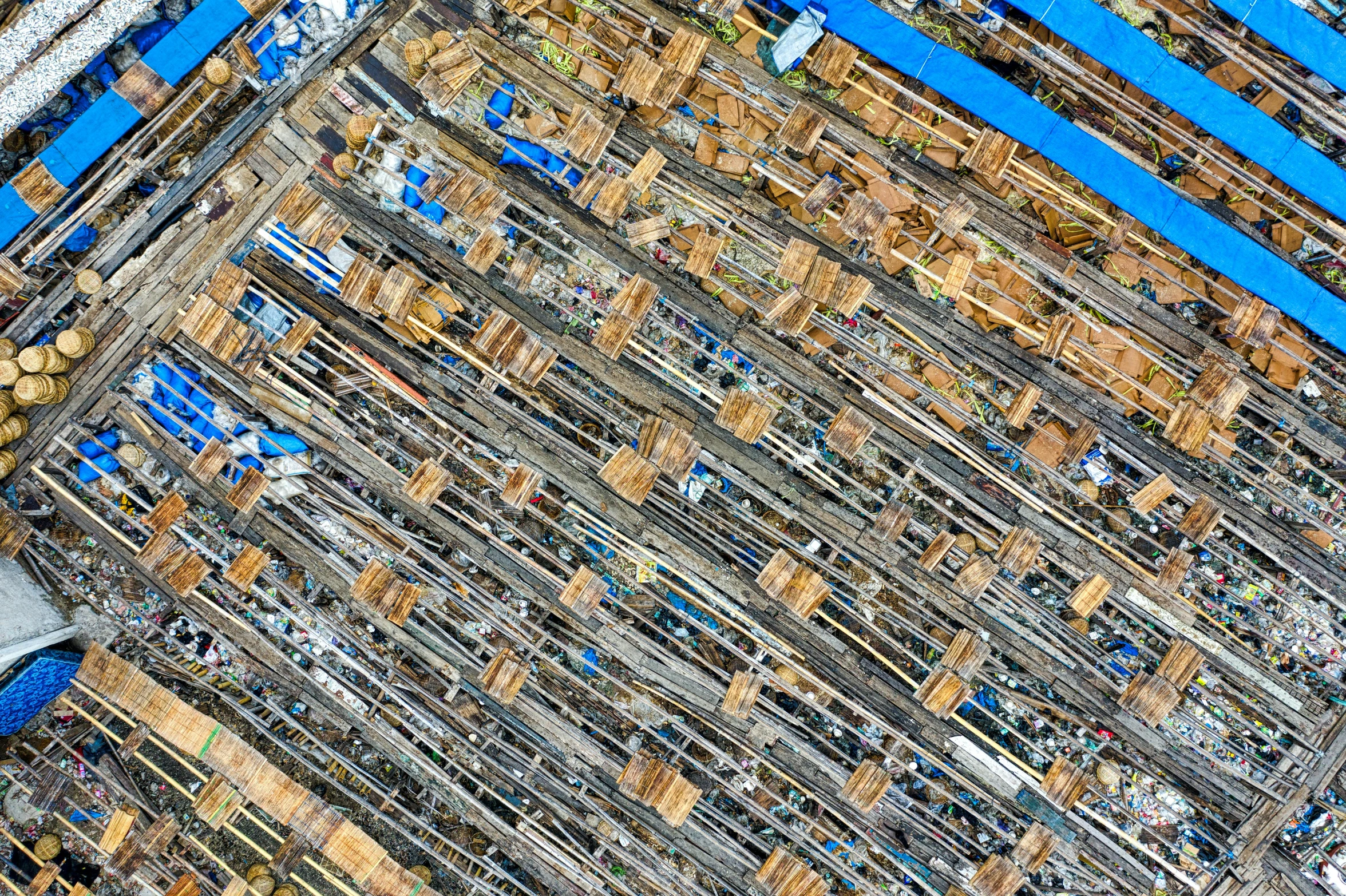 a shopping cart filled with lots of boxes, a mosaic, inspired by Andreas Gursky, unsplash, drone view, hashima island, blue, large scale photo