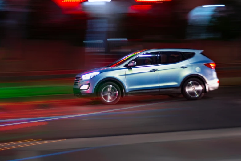 a blue car driving down a street at night, pexels contest winner, photorealism, square, low saturated red and blue light, “hyper realistic, car jump