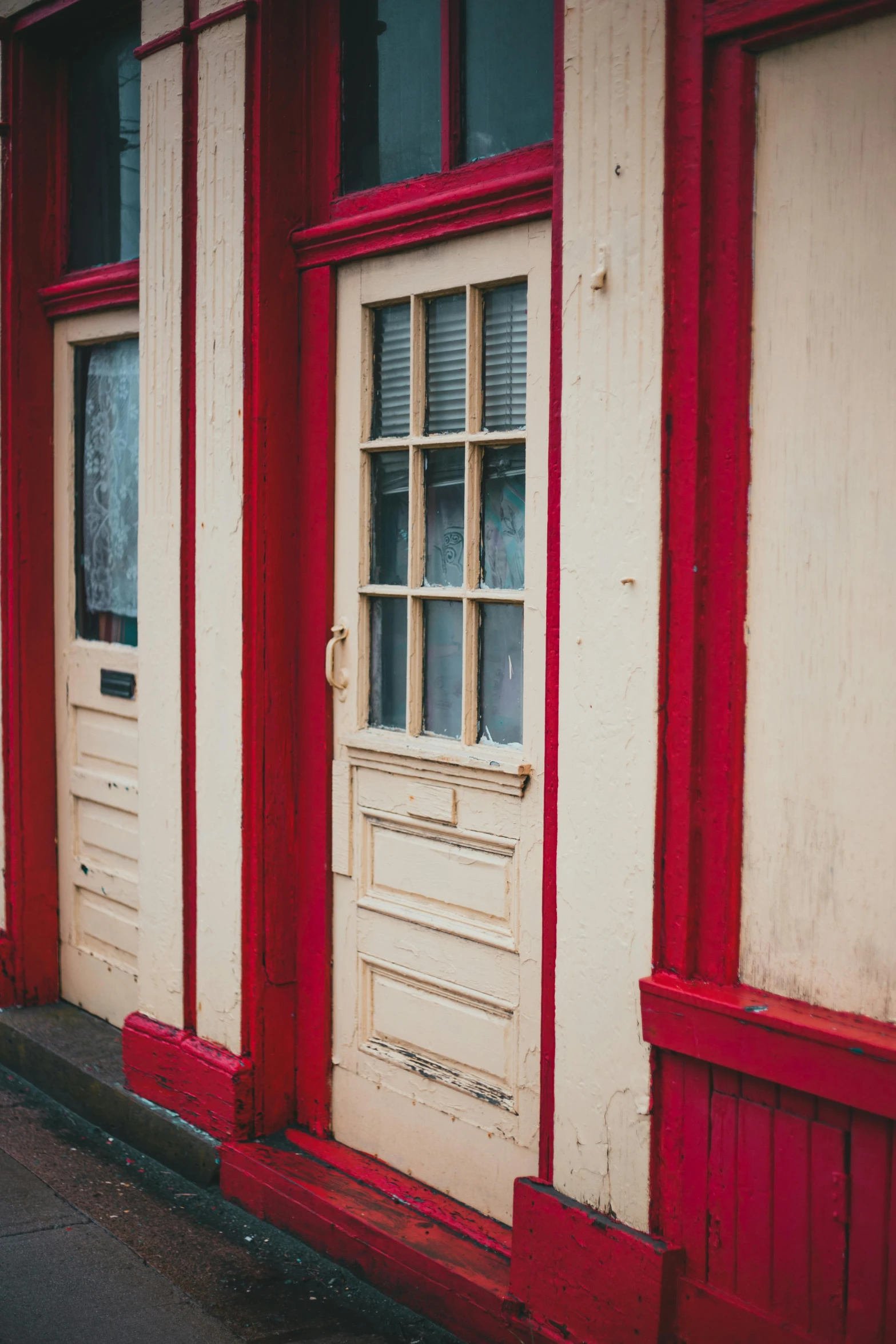 a red and white building with a fire hydrant in front of it, trending on unsplash, wood door, old shops, red paint detail, square