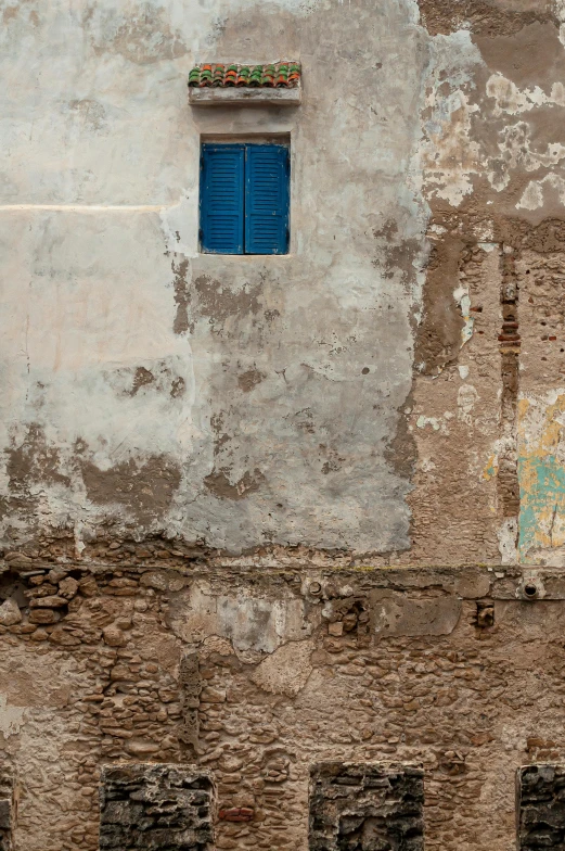 a red fire hydrant sitting in front of a building, an album cover, inspired by Steve McCurry, graffiti, marrakech, windows and walls :5, blues, natural textures