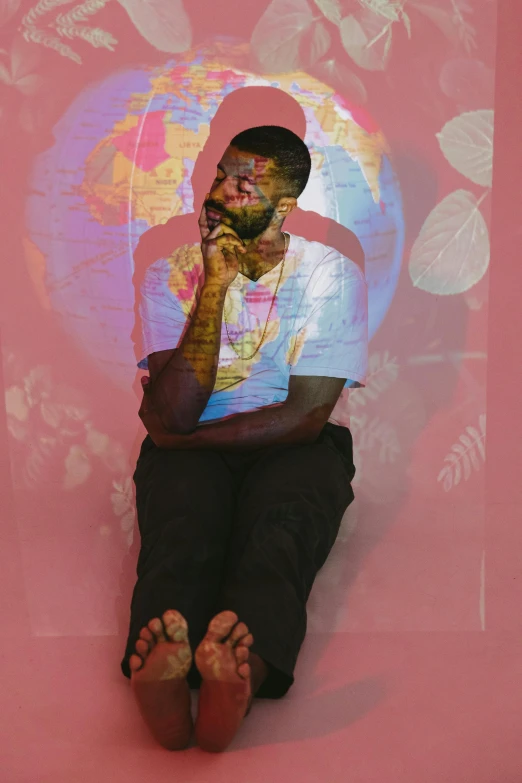 a man sitting on the ground talking on a cell phone, an album cover, inspired by Paul Georges, brightly colored, portrait photo of a backdrop, aaron brooks, ( ( ( colorful ) ) )