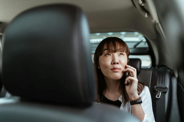 a woman sitting in a car talking on a cell phone, pexels contest winner, happening, ethnicity : japanese, avatar image, square, professional image