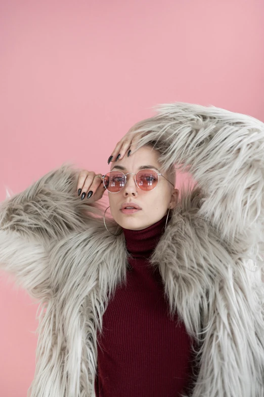 a woman in a fur coat posing for a picture, an album cover, inspired by Elsa Bleda, trending on pexels, pink glasses, circle, modeling shoot, wearing turtleneck