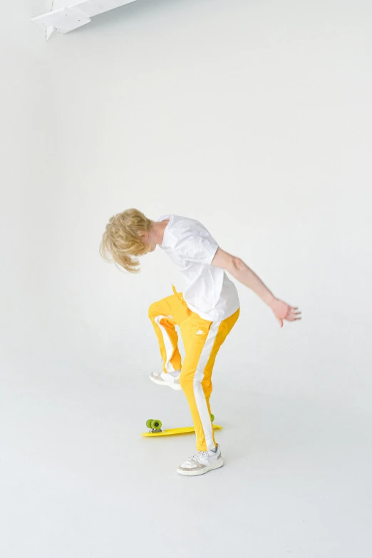 a boy is doing a trick on a skateboard, an album cover, inspired by Graham Forsythe, unsplash, on a white table, blonde boy with yellow eyes, man in adidas tracksuit, fullbody photo