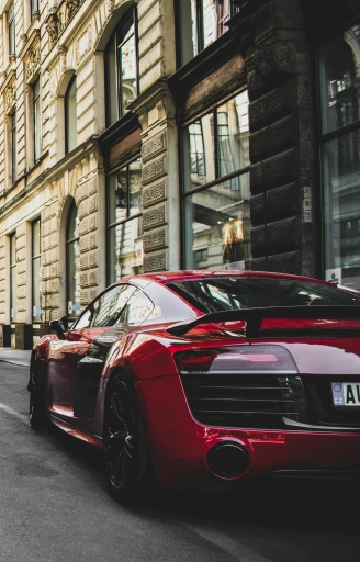 a red sports car driving down a city street, by Adam Marczyński, pexels contest winner, high detail 4k, 🚿🗝📝